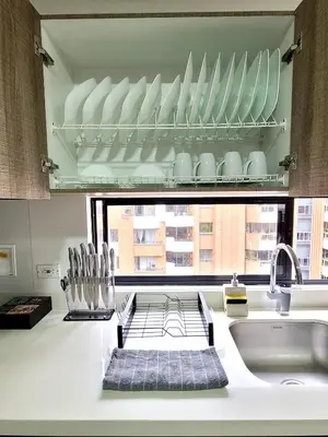 a kitchen with a sink and a window with dishes at New Luxury 3 Bedroom Apartment in Great Area. in Medellín