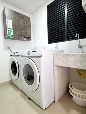 a white washing machine in a bathroom with a sink at New Luxury 3 Bedroom Apartment in Great Area. in Medellín