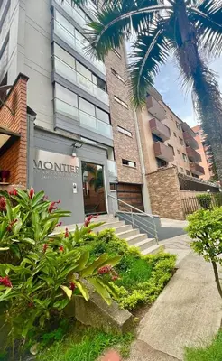 a door to a building with a palm tree at New Luxury 3 Bedroom Apartment in Great Area. in Medellín