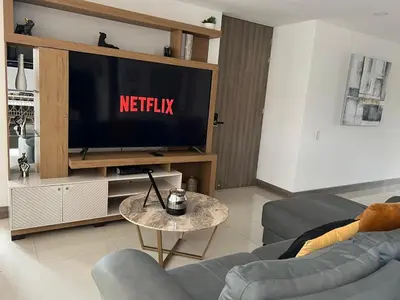 a living room with a television with the netflix sign on it at New Luxury 3 Bedroom Apartment in Great Area. in Medellín