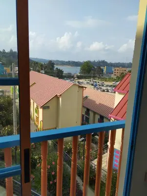a balcony with a view of buildings and a harbor at Apto Nuevo, Tranquilo,Bonito,5 min Plaza Principal in Guatapé
