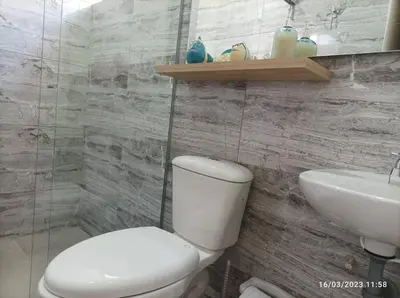 a bathroom with a white toilet and a sink at Apto Nuevo, Tranquilo, Bonito, 5 min Plaza Principal in Guatapé