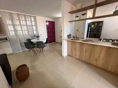 a kitchen and dining room with a table and chairs at Apto Nuevo, Tranquilo a 5 min Plaza Principal in Guatapé