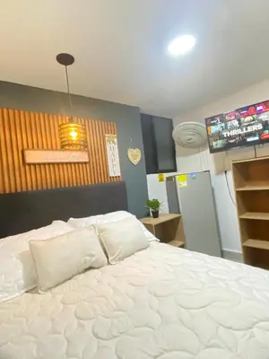a bedroom with a large white bed in a room at HABITACIÓN independiente con COCINA EN LAURELES ESTADIO para 3 personas in Medellín