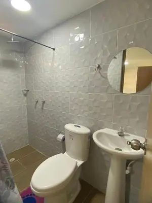 a white bathroom with a toilet and a sink at HABITACIÓN independiente con COCINA EN LAURELES ESTADIO para 3 personas in Medellín