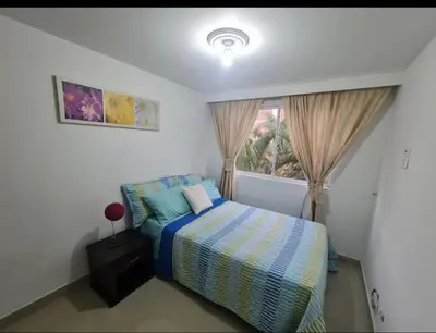 a bedroom with a bed and a window at Apartamento en envigado in Envigado