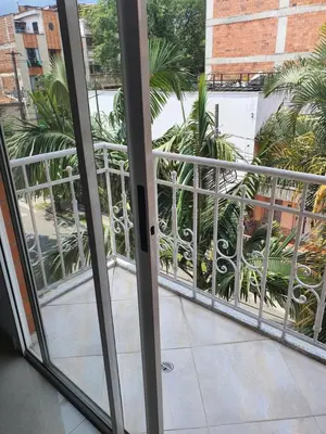 an open door to a balcony with palm trees at Apartamento en envigado in Envigado