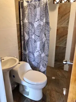 a bathroom with a toilet and a sink at Cabaña el mirador azul in Guatapé