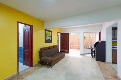 a living room with a couch and yellow walls at La Posada de Sebastian in Medellín