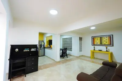 a living room with a couch and a flat screen tv at La Posada de Sebastian in Medellín