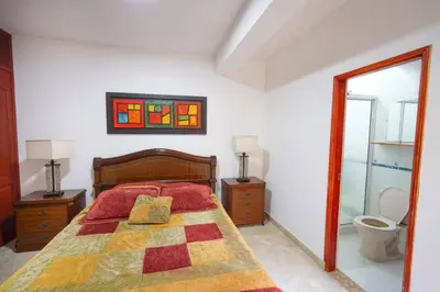 a bedroom with a bed with two pillows on it at La Posada de Sebastian in Medellín