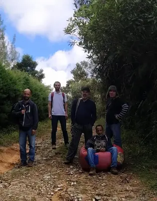 a group of people standing on a dirt road at Cabaña Luna Verde in San Vicente
