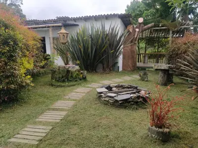 a garden with a stone path in front of a house at Cabaña Luna Verde in San Vicente