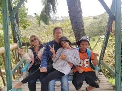a group of people sitting on a swing at Cabaña Luna Verde in San Vicente