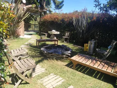 a backyard with two benches and a fire place at Cabaña Luna Verde in San Vicente