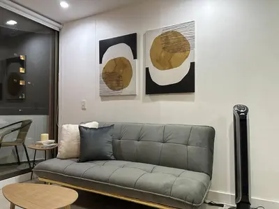 a living room with a couch and some pictures on the wall at Exclusivo Loft en el poblado-rodeado de naturaleza 501 in Medellín