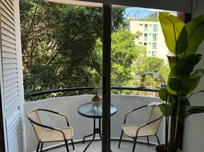 a table and two chairs on a balcony with a view at Exclusivo Loft en el poblado-rodeado de naturaleza 501 in Medellín