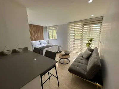 a living room with a couch and a table at Nature and calm in El Poblado 505 in Medellín