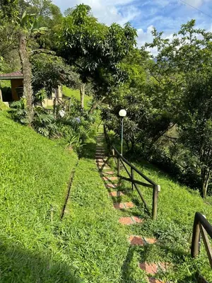 a path in the grass with a fence and trees at Loft bambu in Envigado