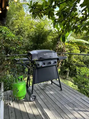 a barbecue grill sitting on a wooden deck at Loft bambu in Envigado
