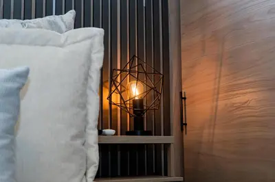 a lamp sitting on a shelf next to a bed at Apartamentos Gema Lujosos en Laureles in Medellín