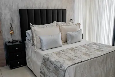 a bedroom with a large bed with white pillows at Apartamentos Gema Lujosos en Laureles in Medellín
