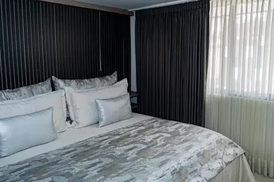 a bedroom with a large bed with white pillows at Apartamentos Gema Lujosos en Laureles in Medellín