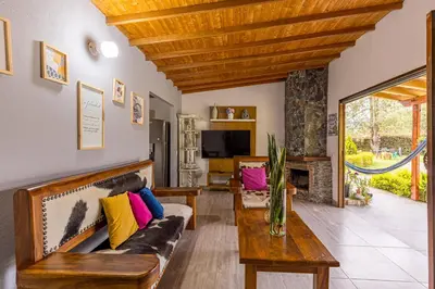 a living room with a couch and a table at Buho Cabaña Santa Elena in Santa Elena