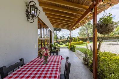 a table with a red and white checkered table cloth at Buho Cabaña Santa Elena in Santa Elena