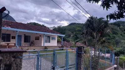 a house with a blue fence in front of it at Cabaña Campestre in La Pintada