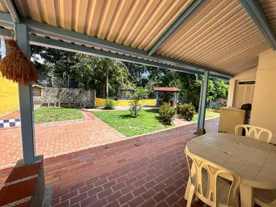 a patio with a table and chairs on a brick patio at Cabaña Campestre in La Pintada