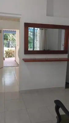 a white room with a mirror and a chair at Cabaña Campestre in La Pintada