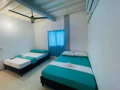 a bedroom with two beds and a window at APARTAMENTO vista VERDE DORADAL in Doradal