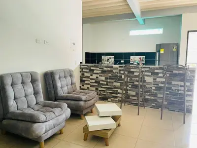 a living room with two chairs and a table at APARTAMENTO vista VERDE DORADAL in Doradal