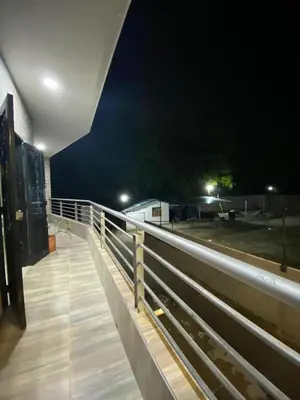 a bridge with a fence and a field at night at APARTAMENTO EN DORADAL A 12 minutos de Nápoles in Doradal