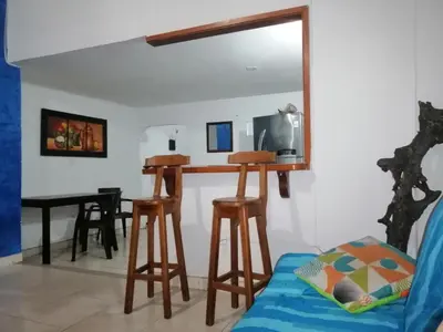 a living room with a table and stools at Casa lowcost relajación in La Dorada