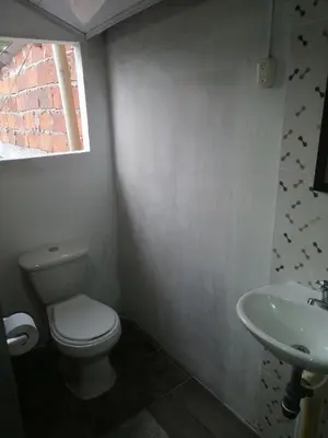 a bathroom with a toilet and a sink at Casa lowcost relajación in La Dorada