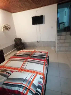 a bedroom with a bed and a flat screen tv at Casa lowcost relajación in La Dorada