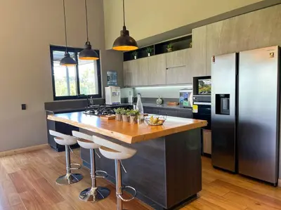 a kitchen with a counter and a refrigerator at Amazing country house! in Rionegro