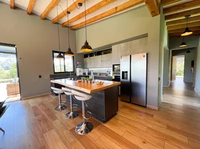 a kitchen with a large island with bar stools at Amazing country house! in Rionegro