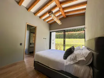 a bedroom with a bed and a large window at Amazing country house! in Rionegro