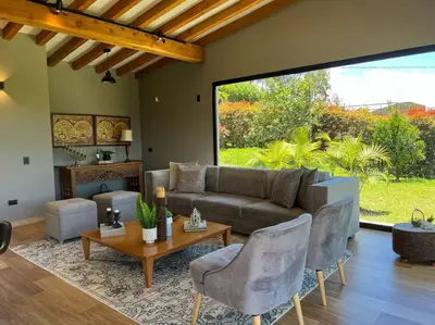 a living room with a couch and a table and chairs at Amazing country house! in Rionegro
