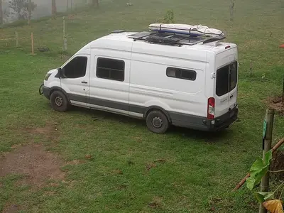 a white van parked in a field of grass at Hostal las Hamacas in Villamaría