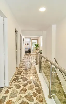 an empty hallway with a stone floor and stairs at 5STARHOMES - Hermosa casa con terraza en Laureles in Medellín