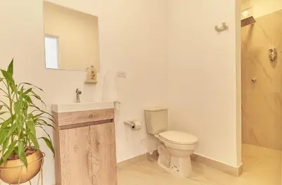 a bathroom with a toilet and a sink at 5STARHOMES - Hermosa casa con terraza en Laureles in Medellín