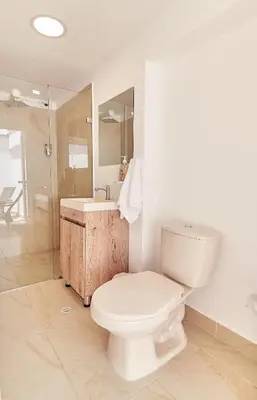 a bathroom with a toilet and a sink and a shower at 5STARHOMES - Hermosa casa con terraza en Laureles in Medellín