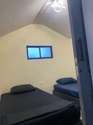 a room with two beds and a window on the wall at Sage house de 2 alcoba la 70 laurles estadio in Medellín