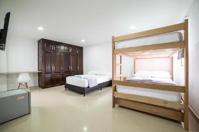 a bedroom with two bunk beds and a desk at Tu Refugio Acogedor en el corazón de Medellín Hab Privada A in Medellín
