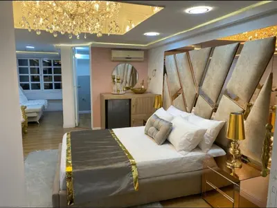 a bedroom with a bed and a chandelier at Nuevo y lujoso apartamento por el lleras (en el poblado ) in Medellín