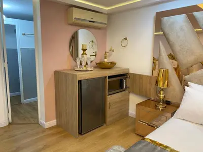 a bedroom with a vanity with a mirror and a bed at Nuevo y lujoso apartamento por el lleras (en el poblado ) in Medellín